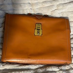 Brown cowhide brief case.
